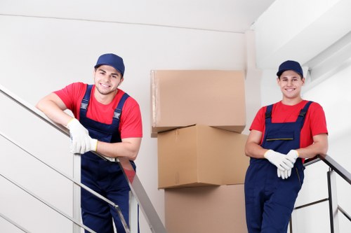 Staff member securing furniture inside a van during loading