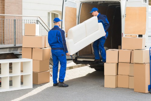 Packed moving boxes and furniture ready for transport in South London