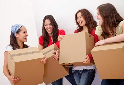 Professional movers transporting a piano through a residential area