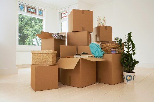 Professional movers navigating stairs during a local apartment removal